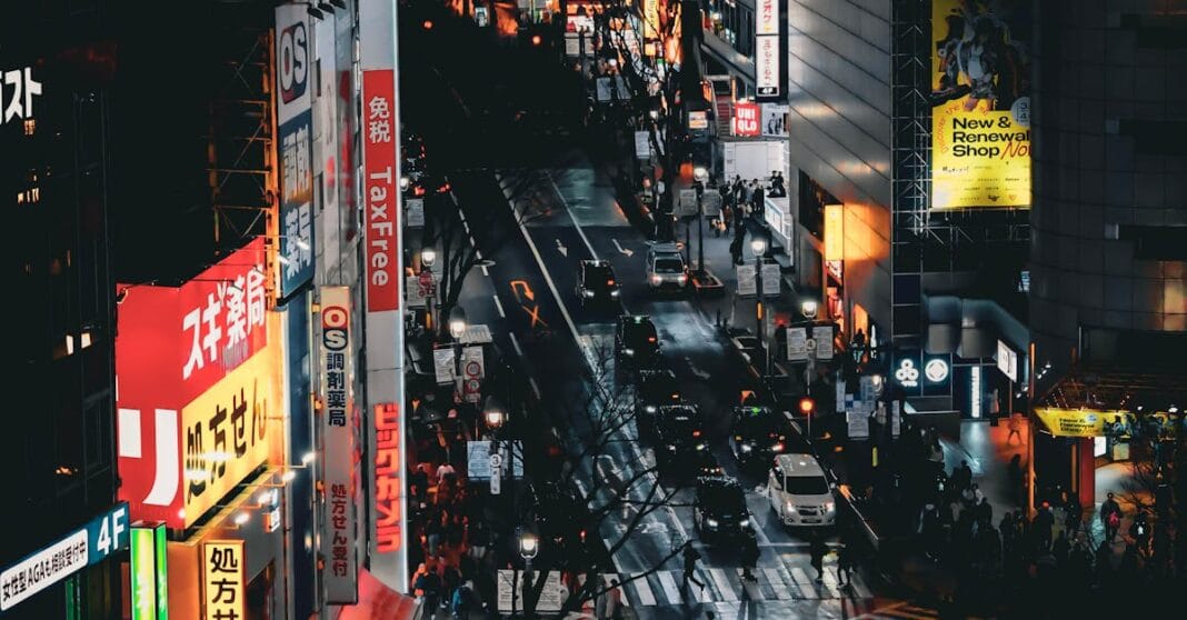 A bustling night scene at Shibuya Crossing in Tokyo, Japan, showcasing vibrant city lights and urban life.